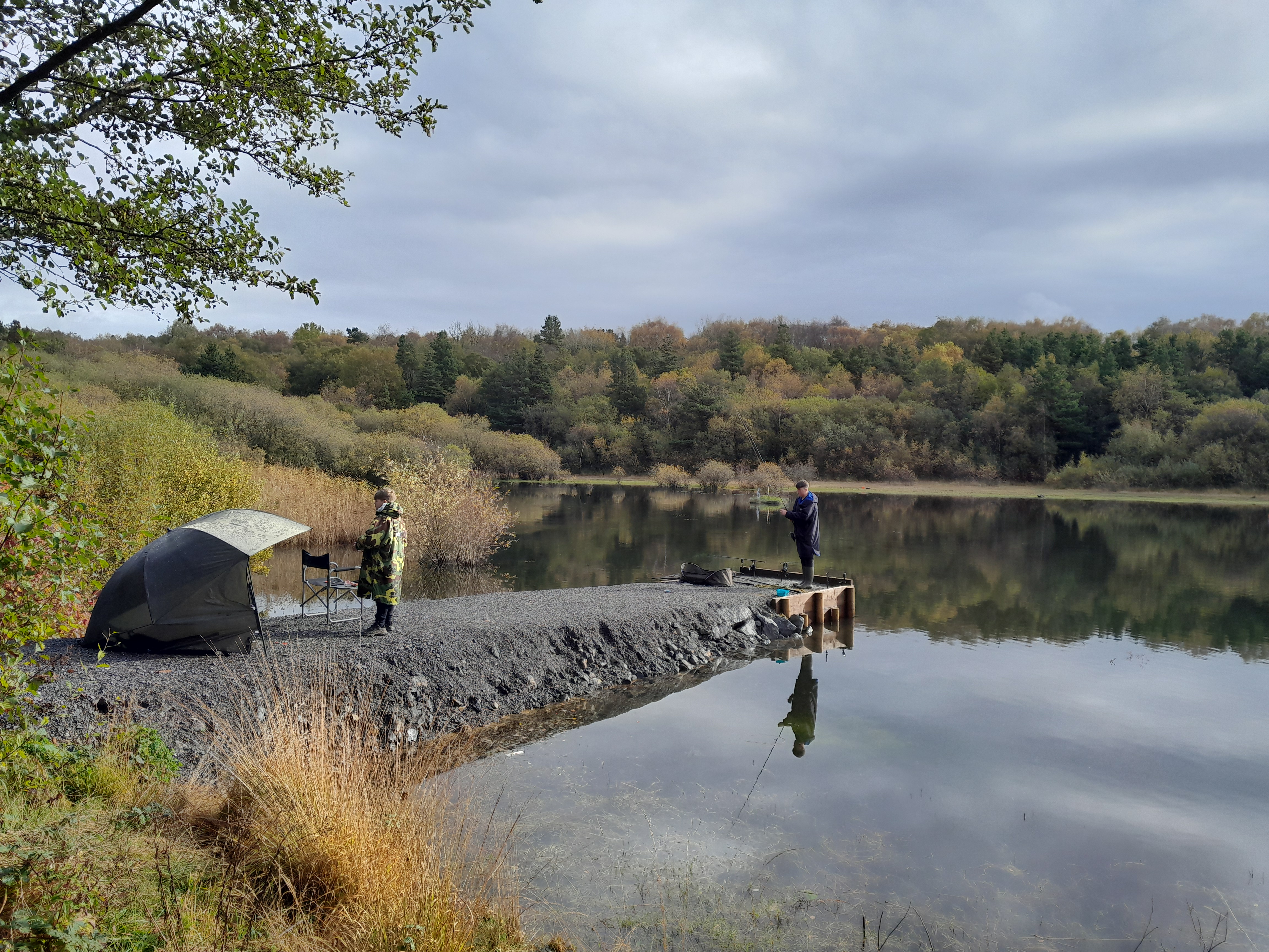 Dau bysgotwr yn pysgota ger Llyn Pluck